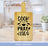 Bamboo cutting board with "Cook Pray Eat" text and kitchen background.