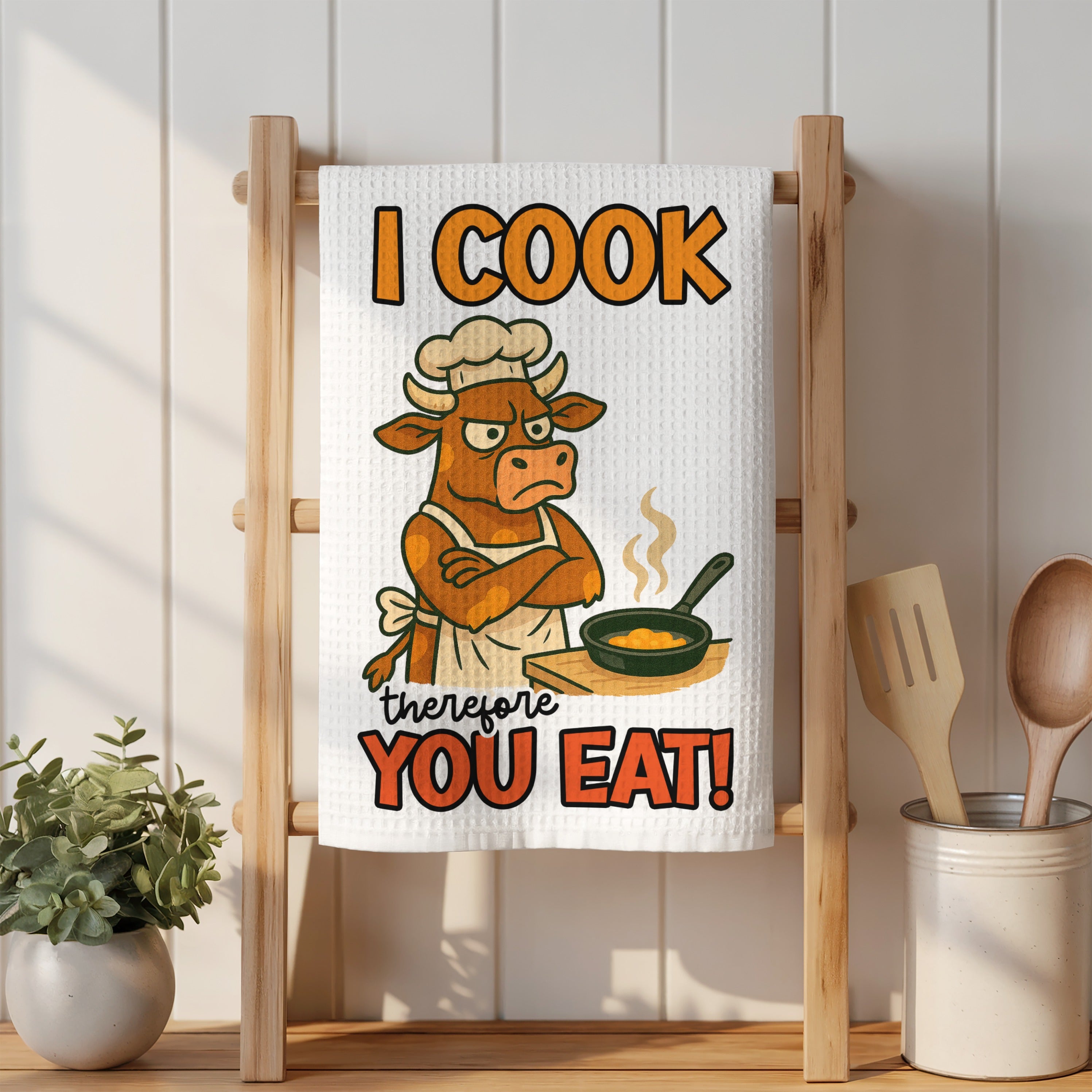 Towel with cartoon cow chef and text "I COOK THEREFORE YOU EAT!"