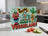 Welcome to Veggieland sign with cartoon vegetables and kitchen background.