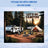 Camper, tent, chairs, and table set up for camping with text "Let's Go Camping".