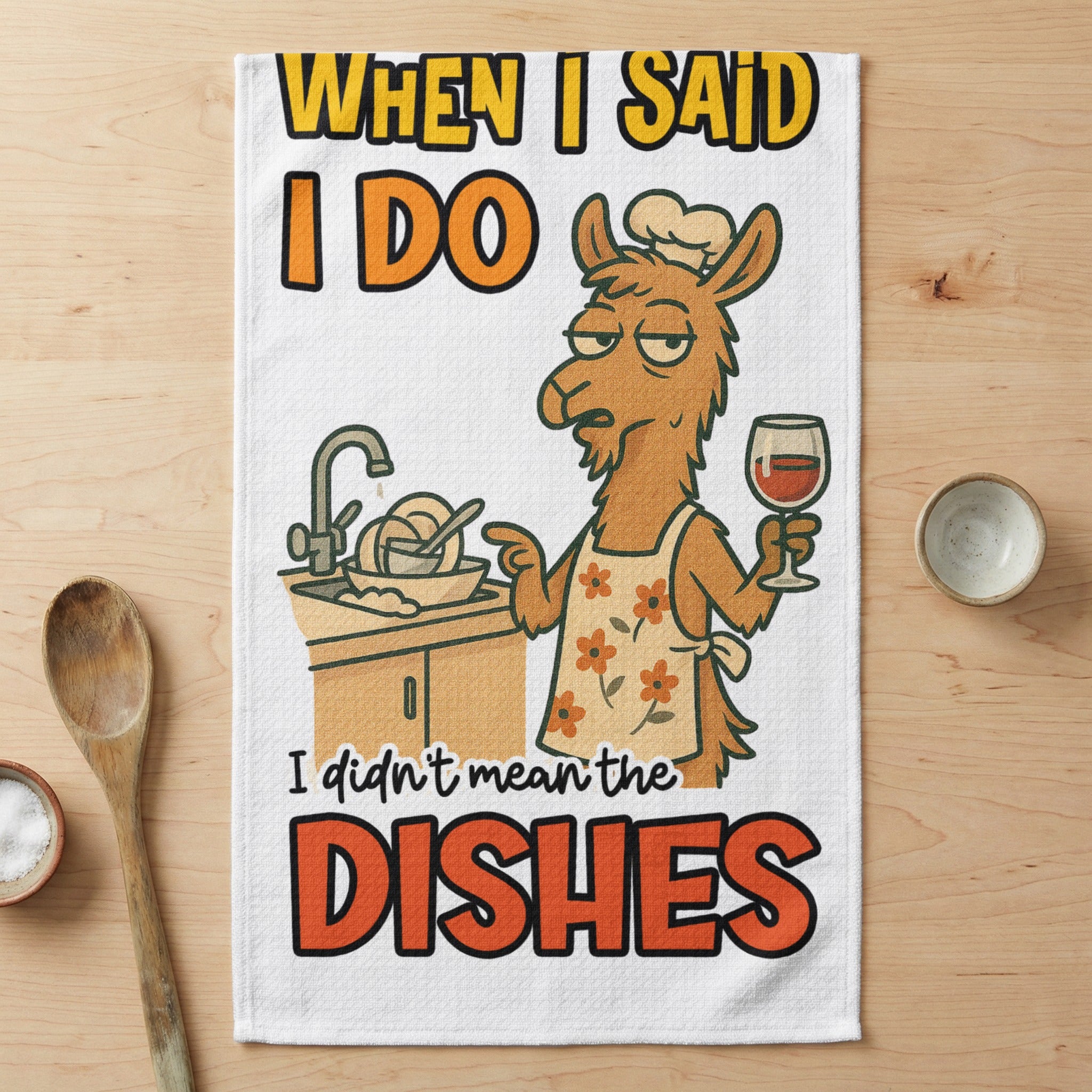 Cartoon llama in apron holding wine glass with text "When I said I do I didn't mean the dishes."