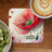Coaster with a red poppy and ladybug, "Act NOW" text, and a cup of coffee.