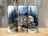 Watercolor camping scene with trailer, campfire, and chairs on wooded background.