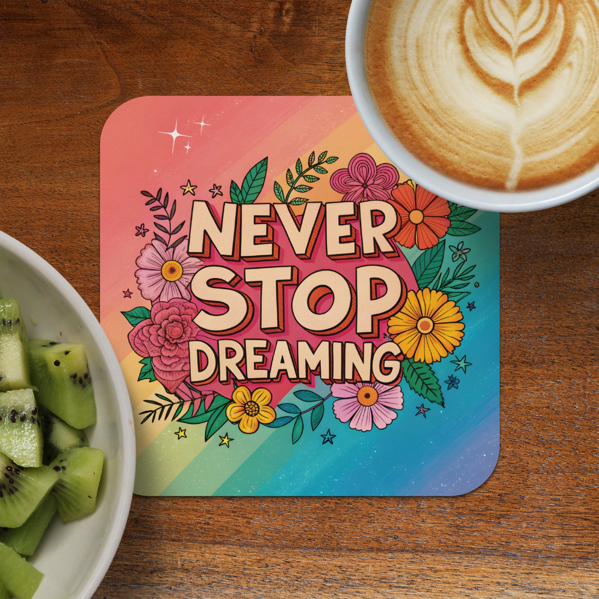 Coaster with "Never Stop Dreaming" text surrounded by flowers and stars.