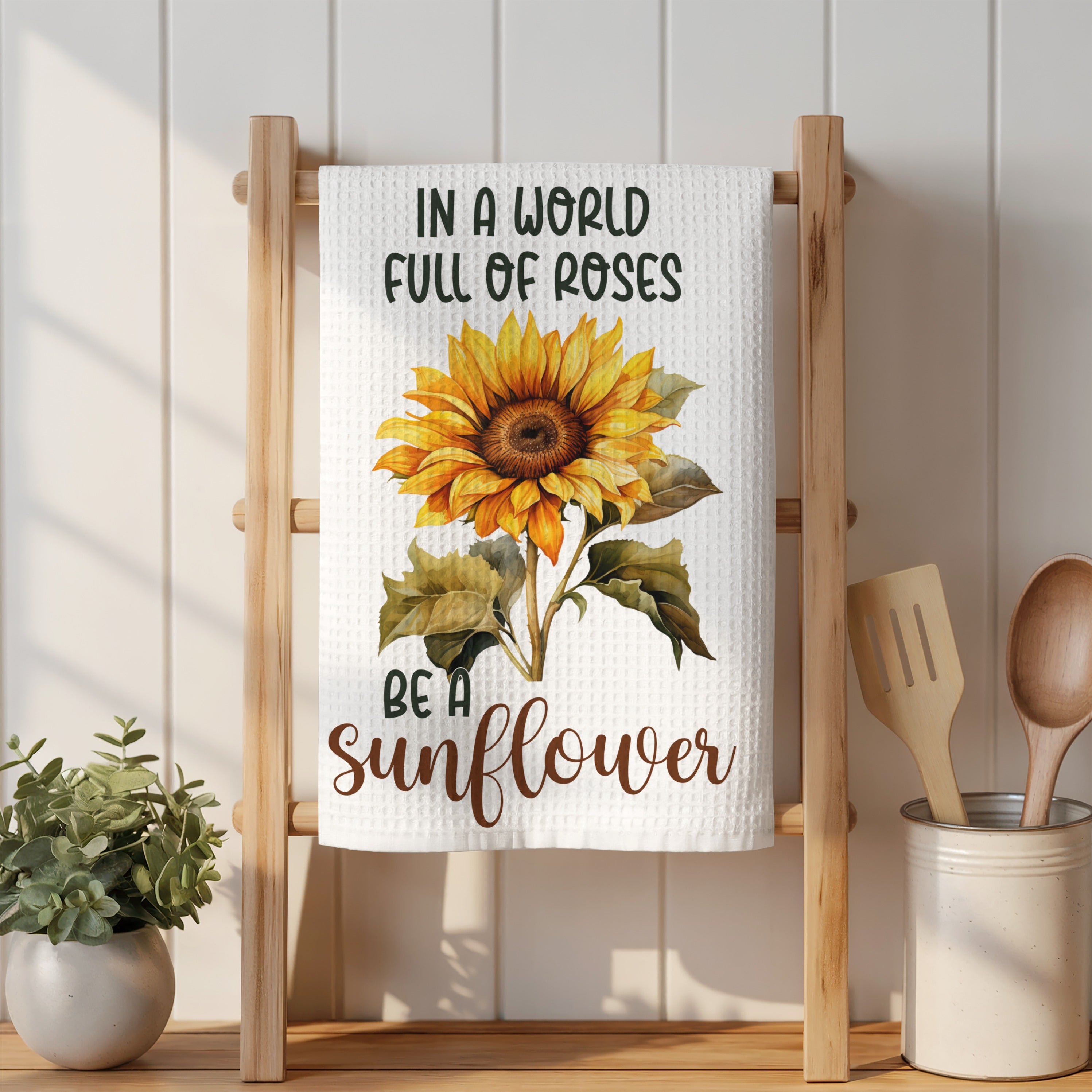 Sunflower with "Be a sunflower" text on a kitchen towel.