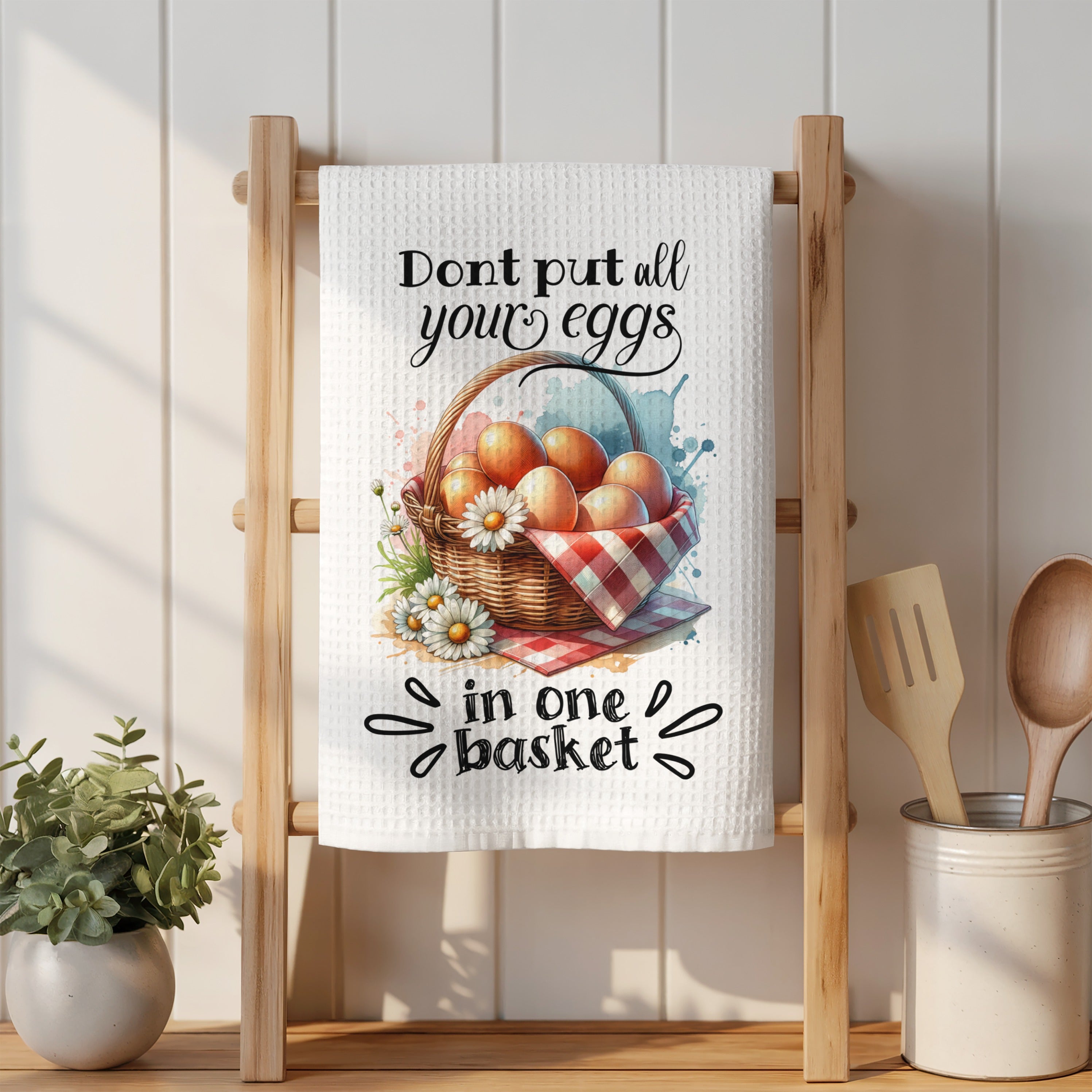 White waffle weave towel with eggs in a basket illustration and text.