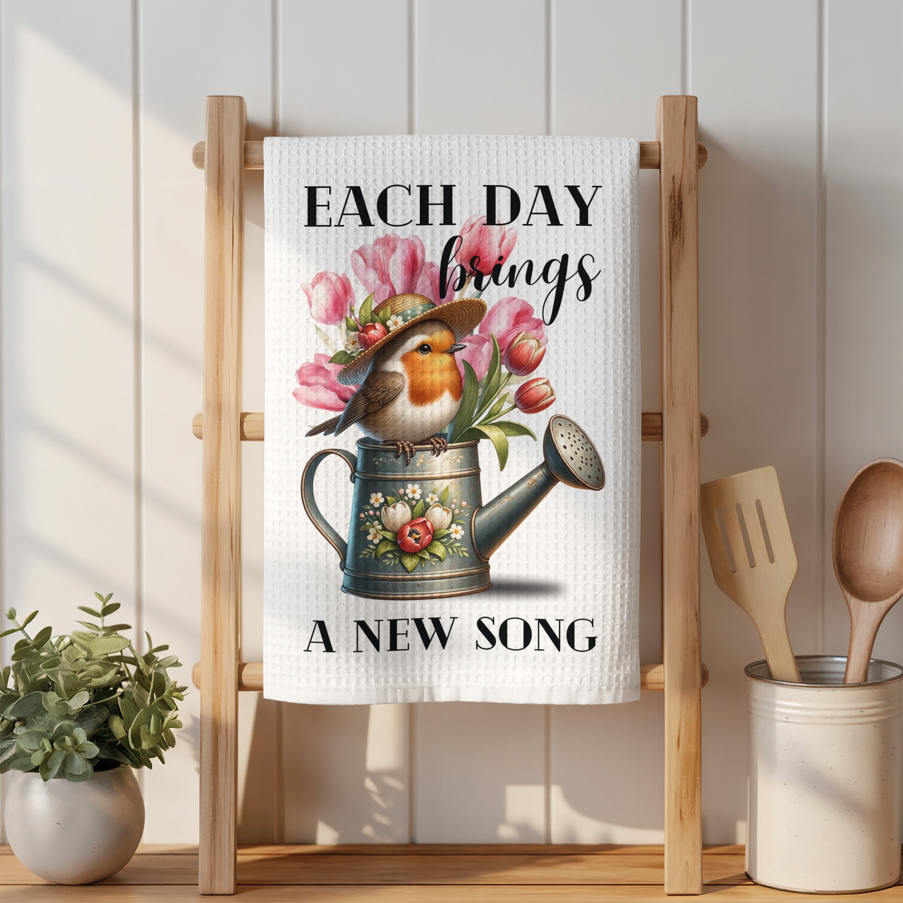 Towel with robin in watering can and "Each Day Brings A New Song" text.