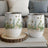 Two white wine tumblers with a watercolor floral and bee pattern.