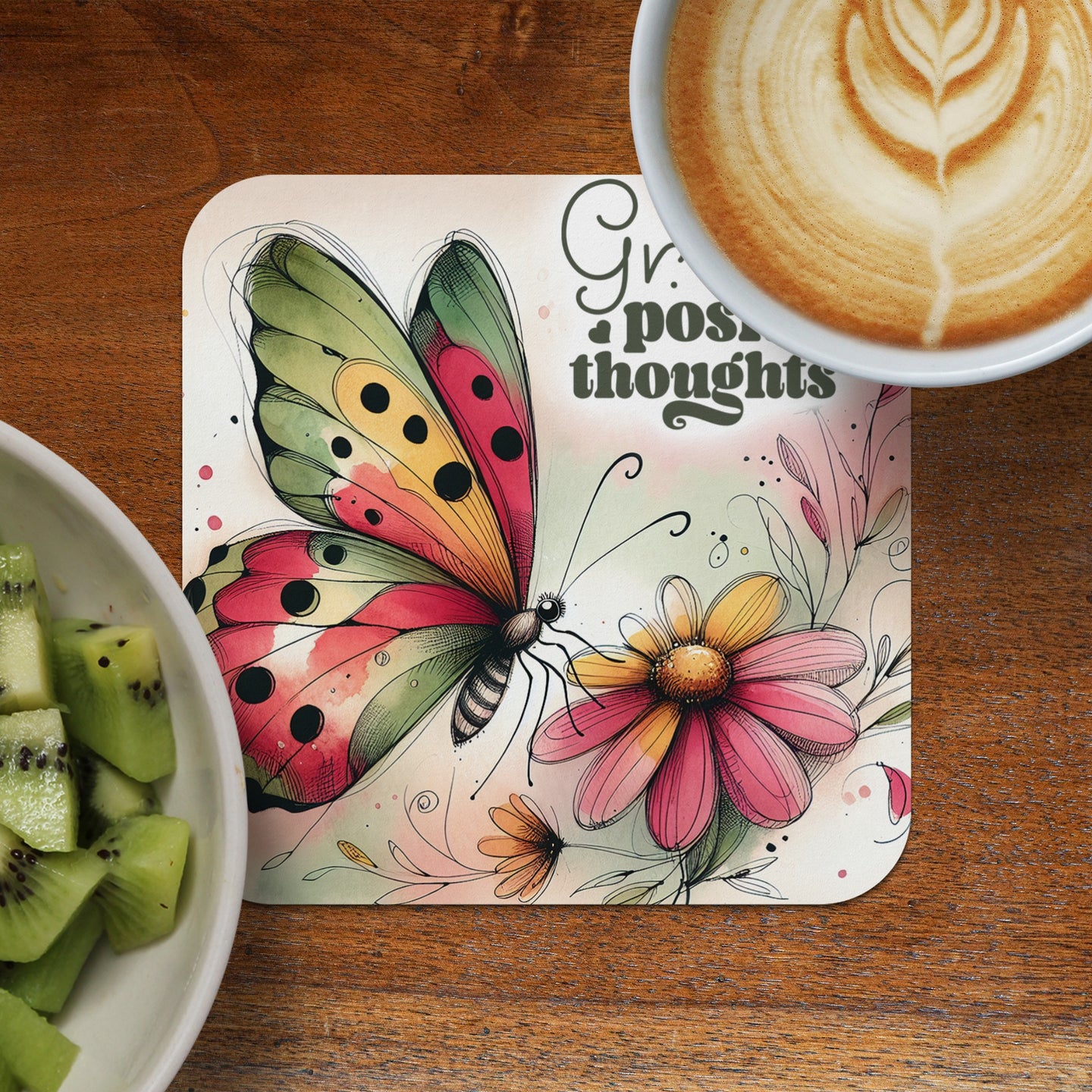 Coaster with watercolor butterfly on pink flower, "Great thoughts" text, and coffee.