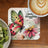 Coaster with watercolor butterfly on pink flower, "Great thoughts" text, and coffee.