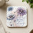 Coaster with purple and white daisies and text "live a great story."