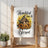 White kitchen towel with sunflowers, birdhouse, and "Thankful and Blessed" text.