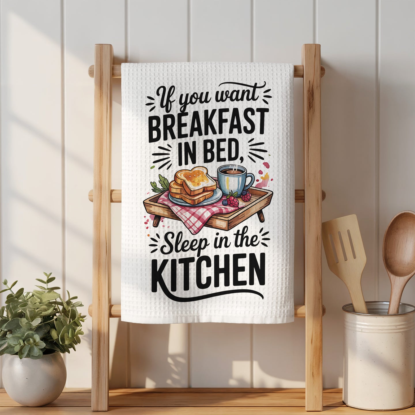 Towel with "If you want breakfast in bed, sleep in the kitchen" text and illustration.