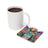 Woman with butterfly wings on coaster next to coffee mug.