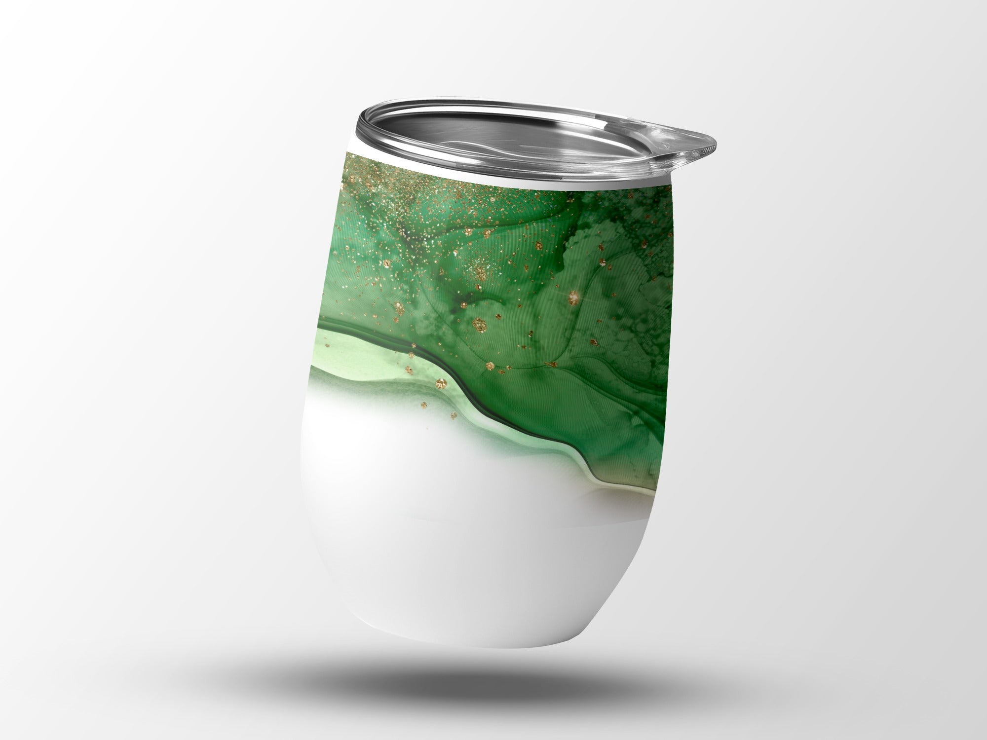 White tumbler with green and gold abstract fluid art design.