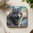 Wolf portrait with mountains and forest in background on a coaster.