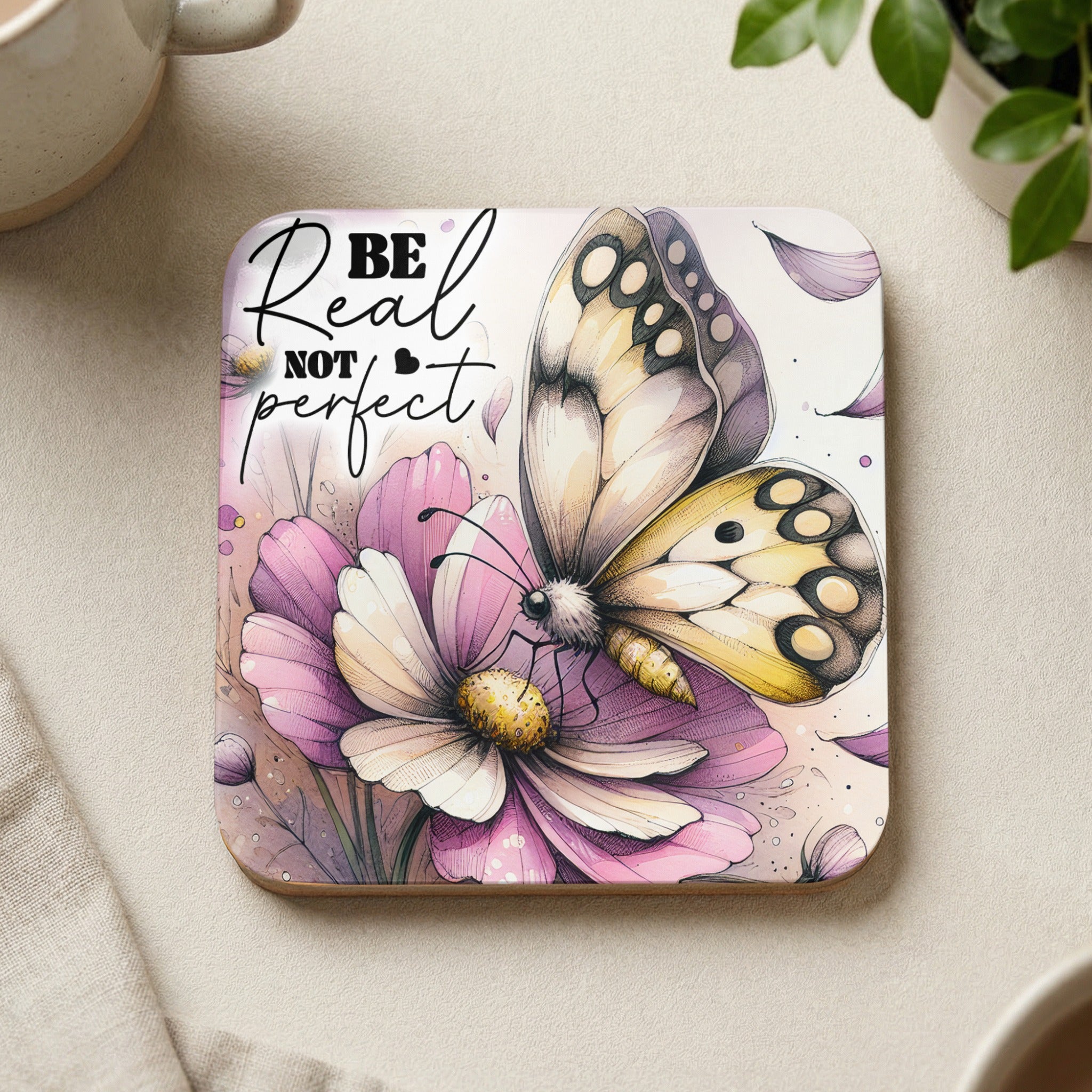 Coaster with butterfly on flower, text "Be real not perfect."