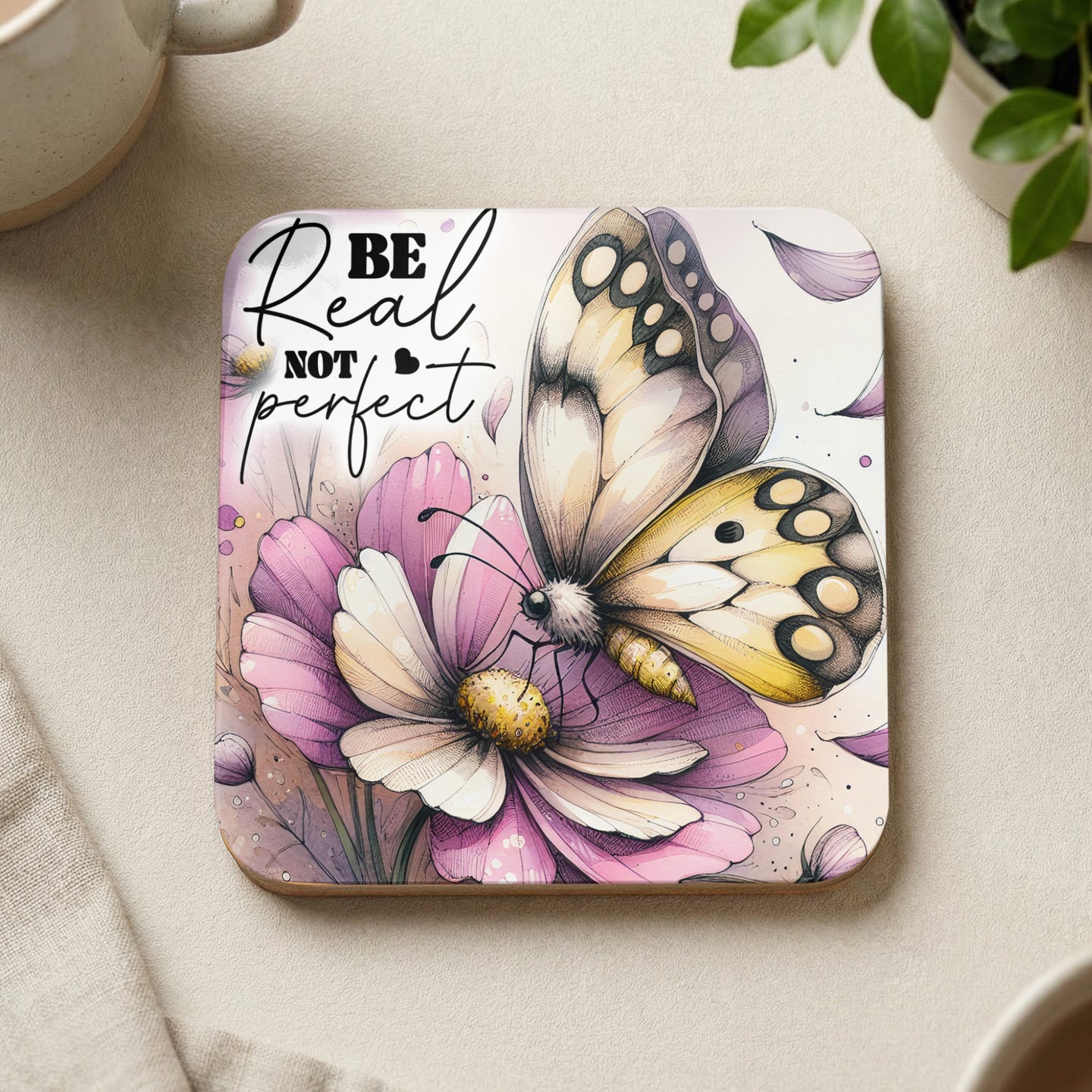 Coaster with butterfly on flower, text "Be real not perfect."