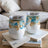 Two white insulated tumblers with gold and blue balloon design.