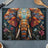Colorful mosaic elephant design on a glass cutting board with flowers.