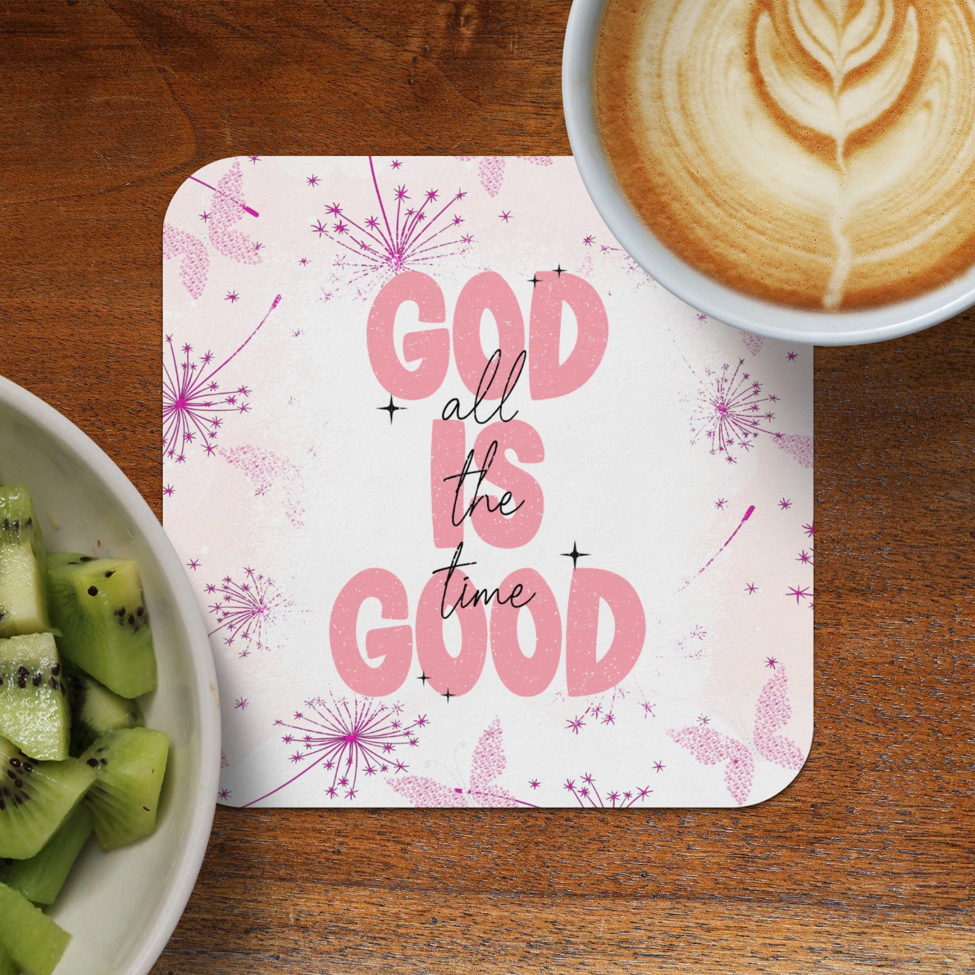 Round coaster with "God is good all the time" text, coffee, and kiwi.