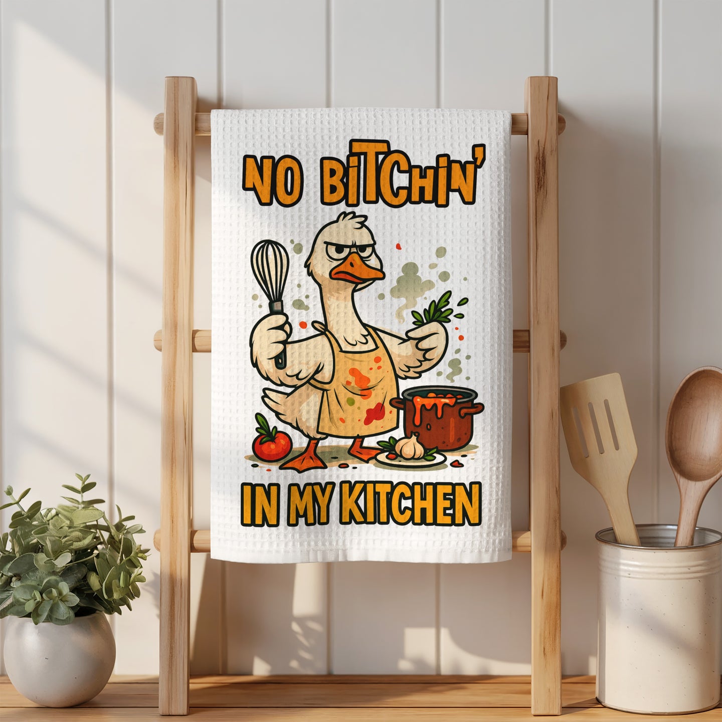Cartoon duck wearing apron holding herbs, NO Bitchin' IN MY KITCHEN text.