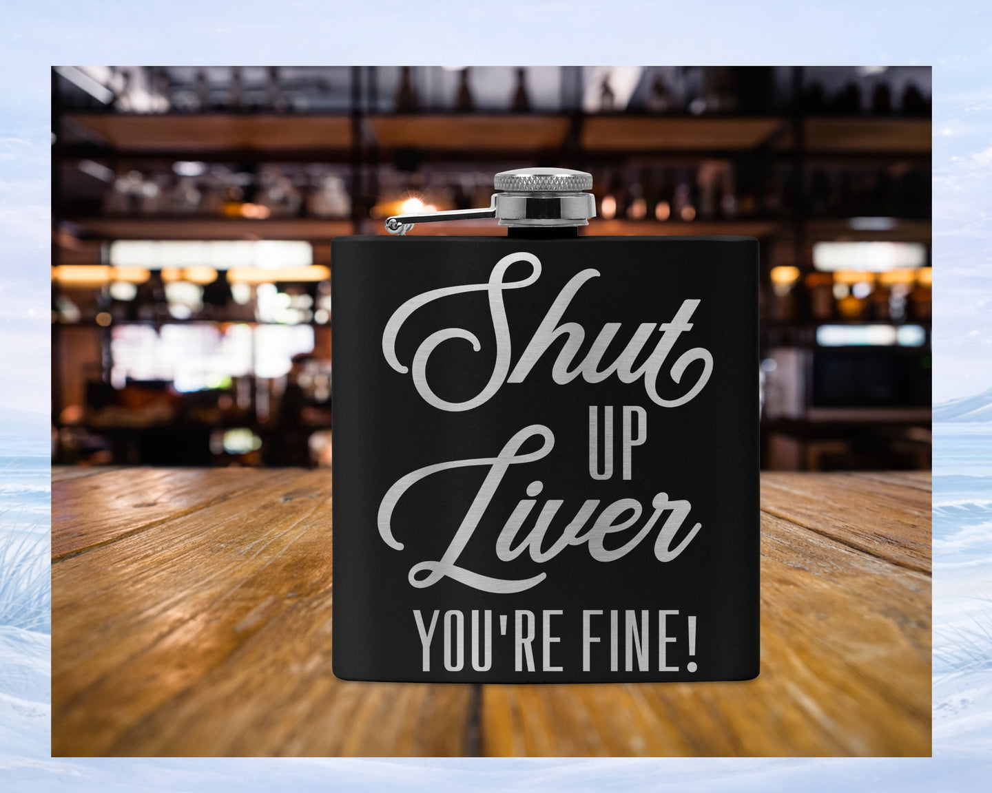 Black flask with "Shut Up Liver You're Fine!" text on wooden surface.
