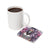 Square coaster with tattooed woman and roses, next to a mug of coffee.