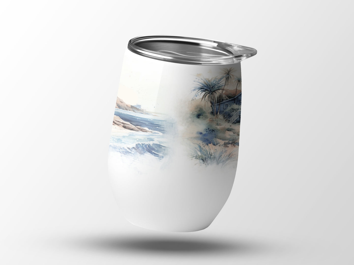 White tumbler with a watercolor beach and palm tree design.