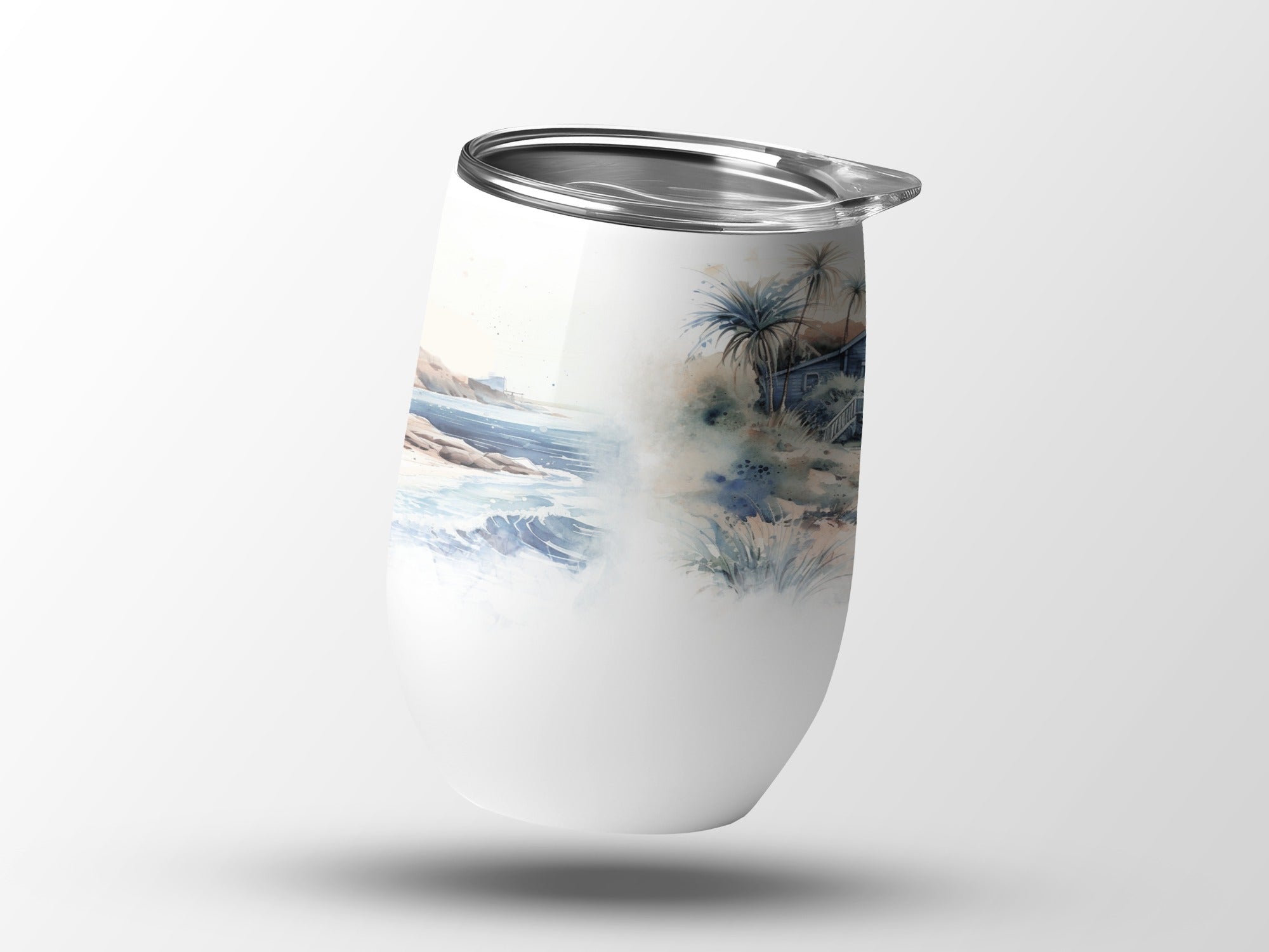 White tumbler with a watercolor beach and palm tree design.