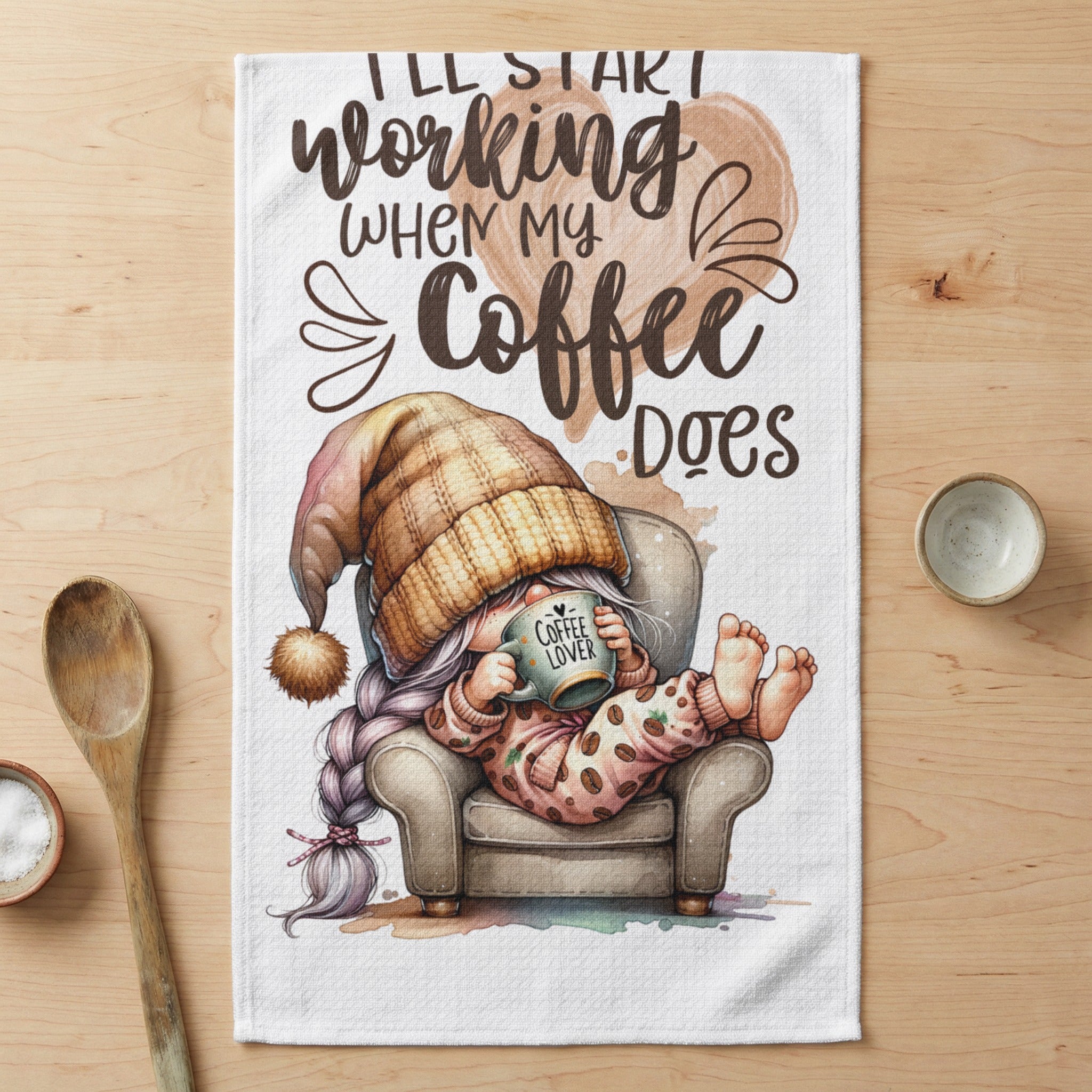 Gnome in pajamas and beanie, drinking coffee in armchair, with text "I'll start working when my coffee does".