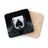 Black ace of spades card splashing in dark liquid, on a coaster.