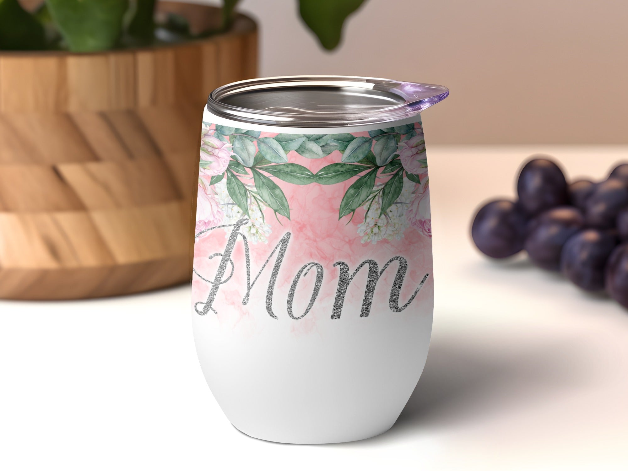 White tumbler with "Mom" in glittery script and a floral watercolor design.