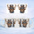 Steampunk deer head with top hat and goggles on white mugs against snowy background.