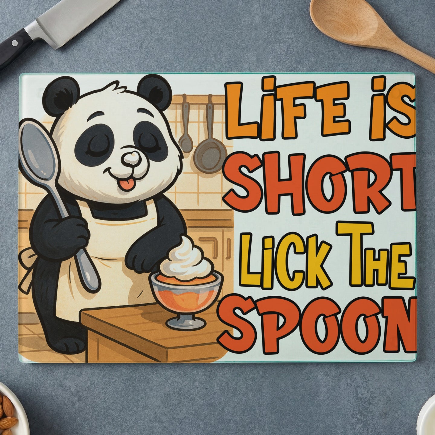 Panda wearing apron, holding spoon, next to bowl of whipped cream, text "Life is short lick the spoon".