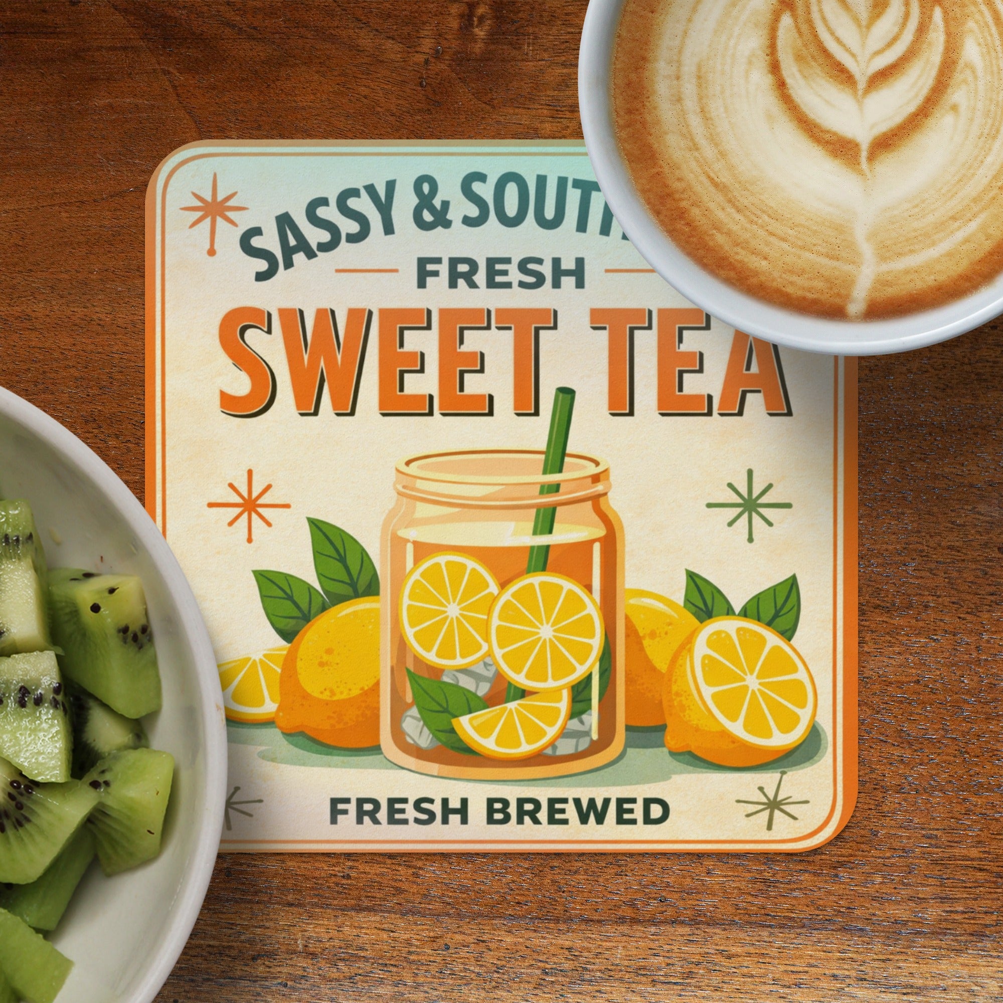 Sassy & South Sweet Tea coasters with sliced oranges and a latte.