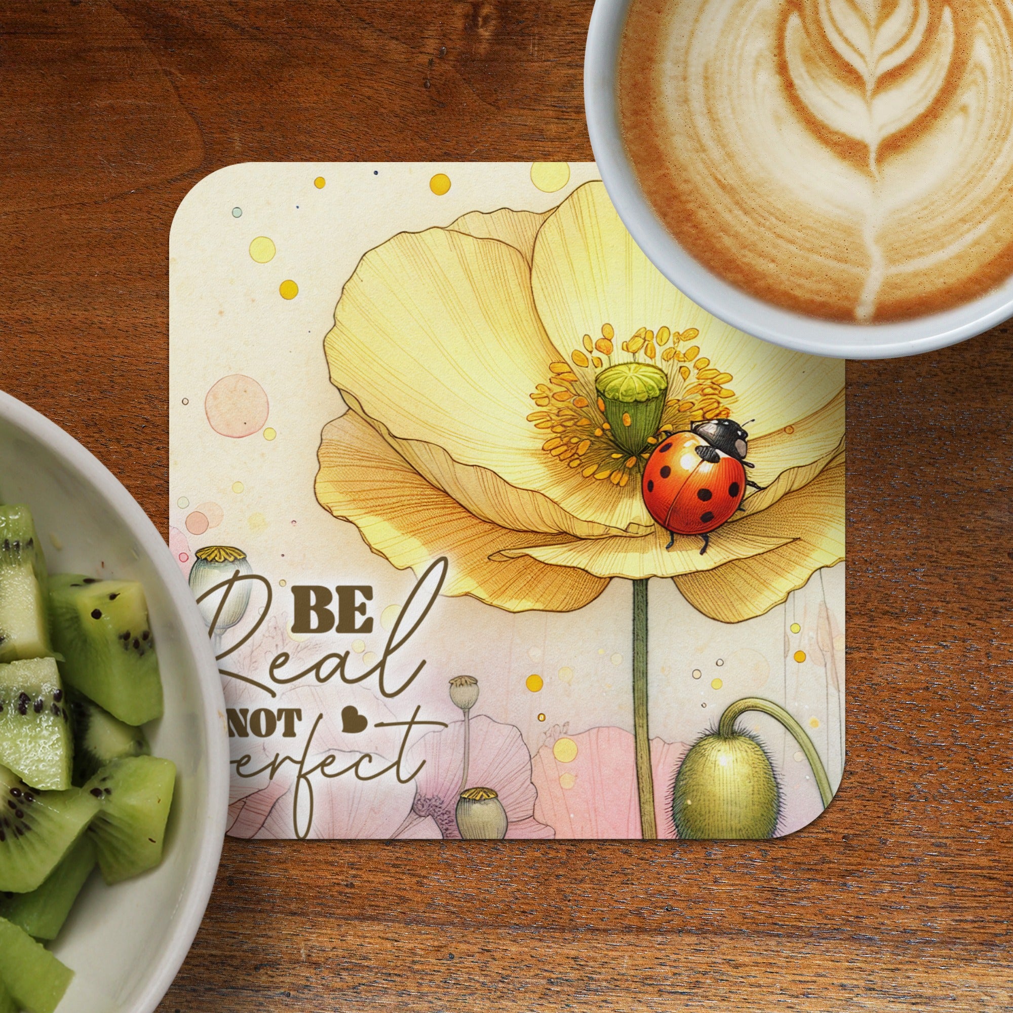 Coaster with yellow poppy, ladybug, and "Be real not perfect" text.