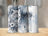 Snow leopard and dreamcatcher design on three skinny tumblers with blue text "Amelia".