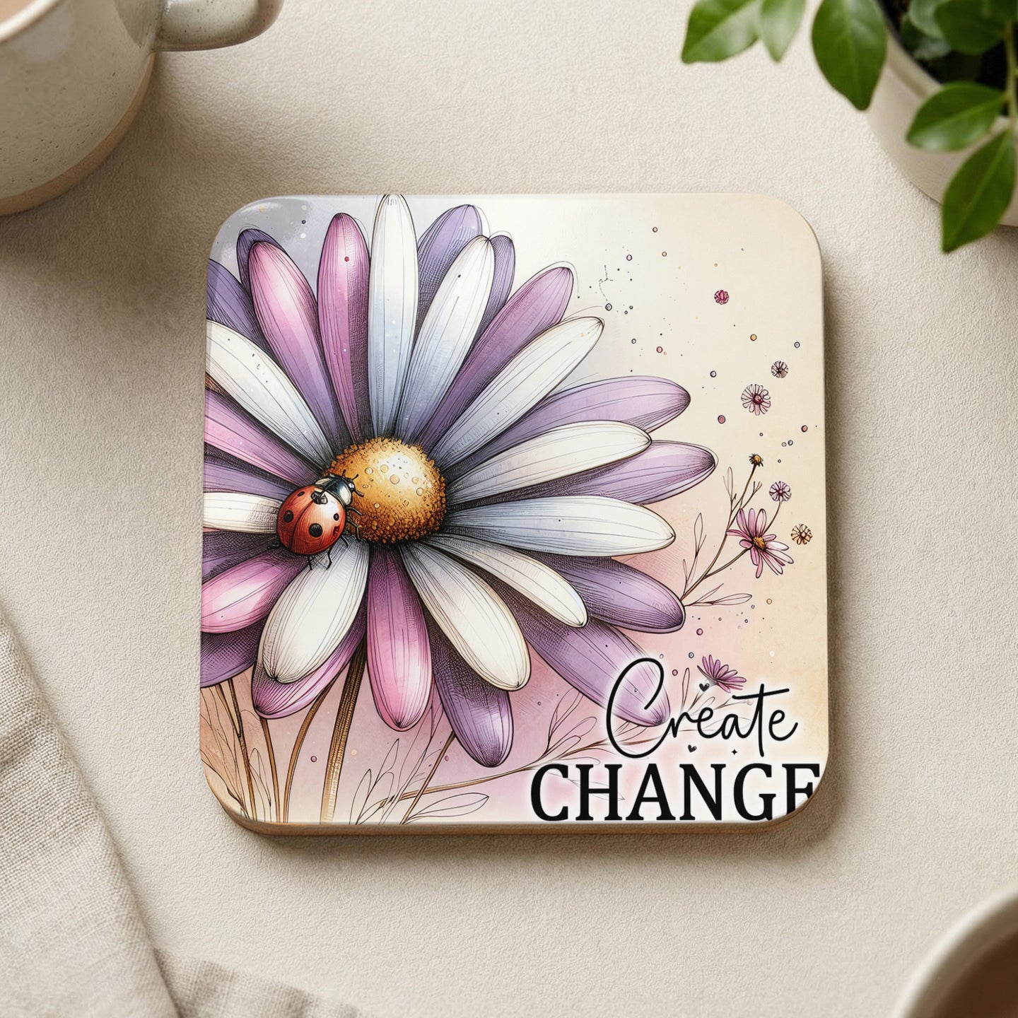 Coaster with a daisy, ladybug, and "Create Change" text.