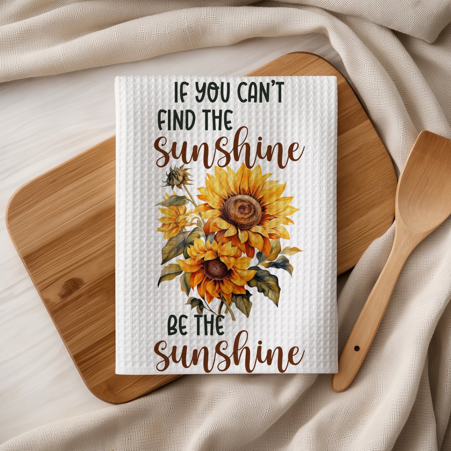 Kitchen towel with sunflowers and "If you can't find the sunshine, be the sunshine" text.