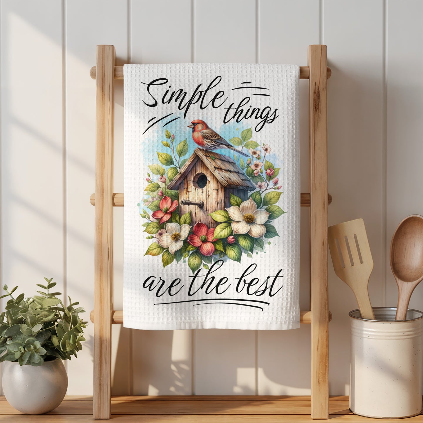 White kitchen towel with "Simple things are the best" and a birdhouse illustration.