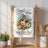 White kitchen towel with "Simple things are the best" and a birdhouse illustration.