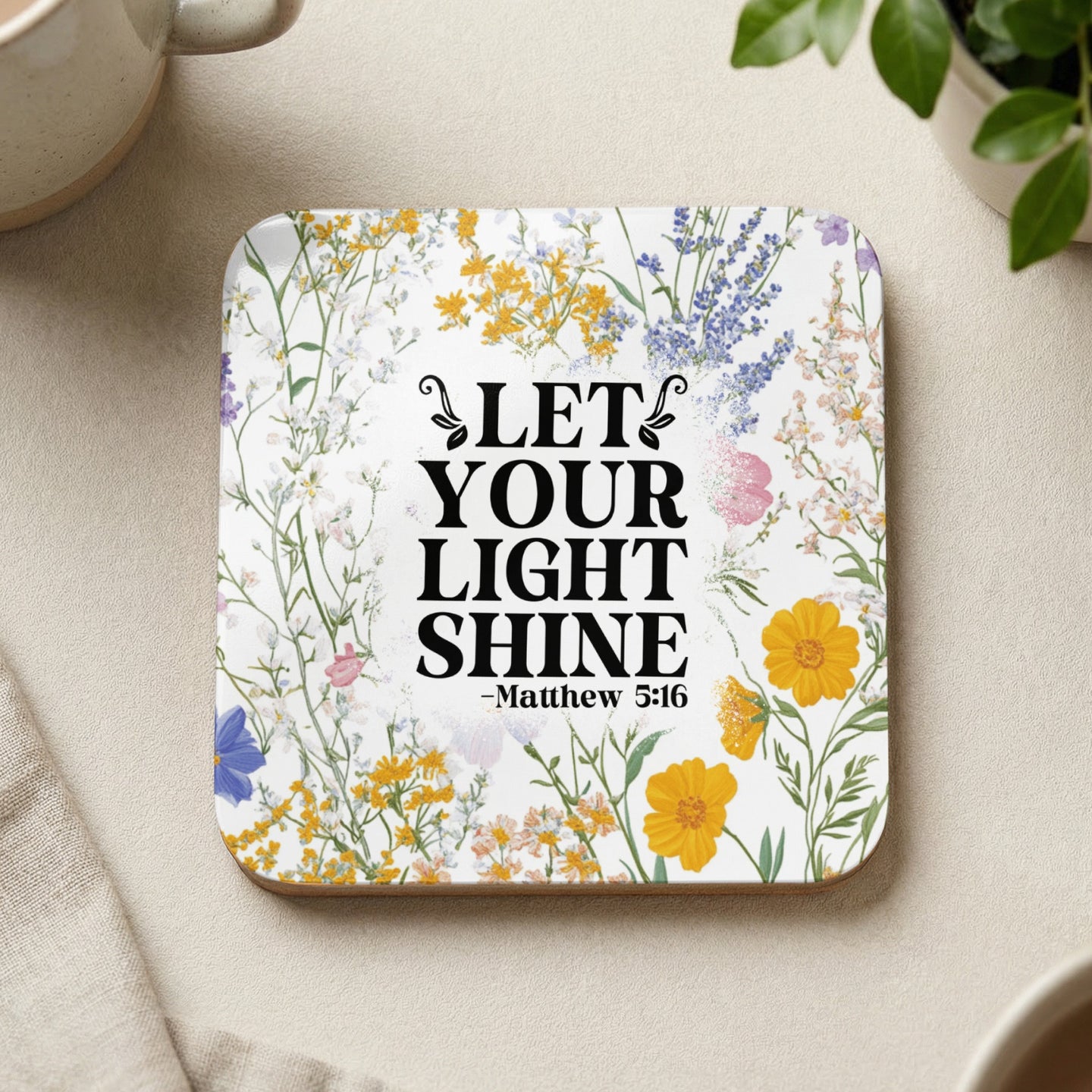 Square coaster with floral design and "Let Your Light Shine" from Matthew 5:16.