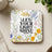 Square coaster with floral design and "Let Your Light Shine" from Matthew 5:16.