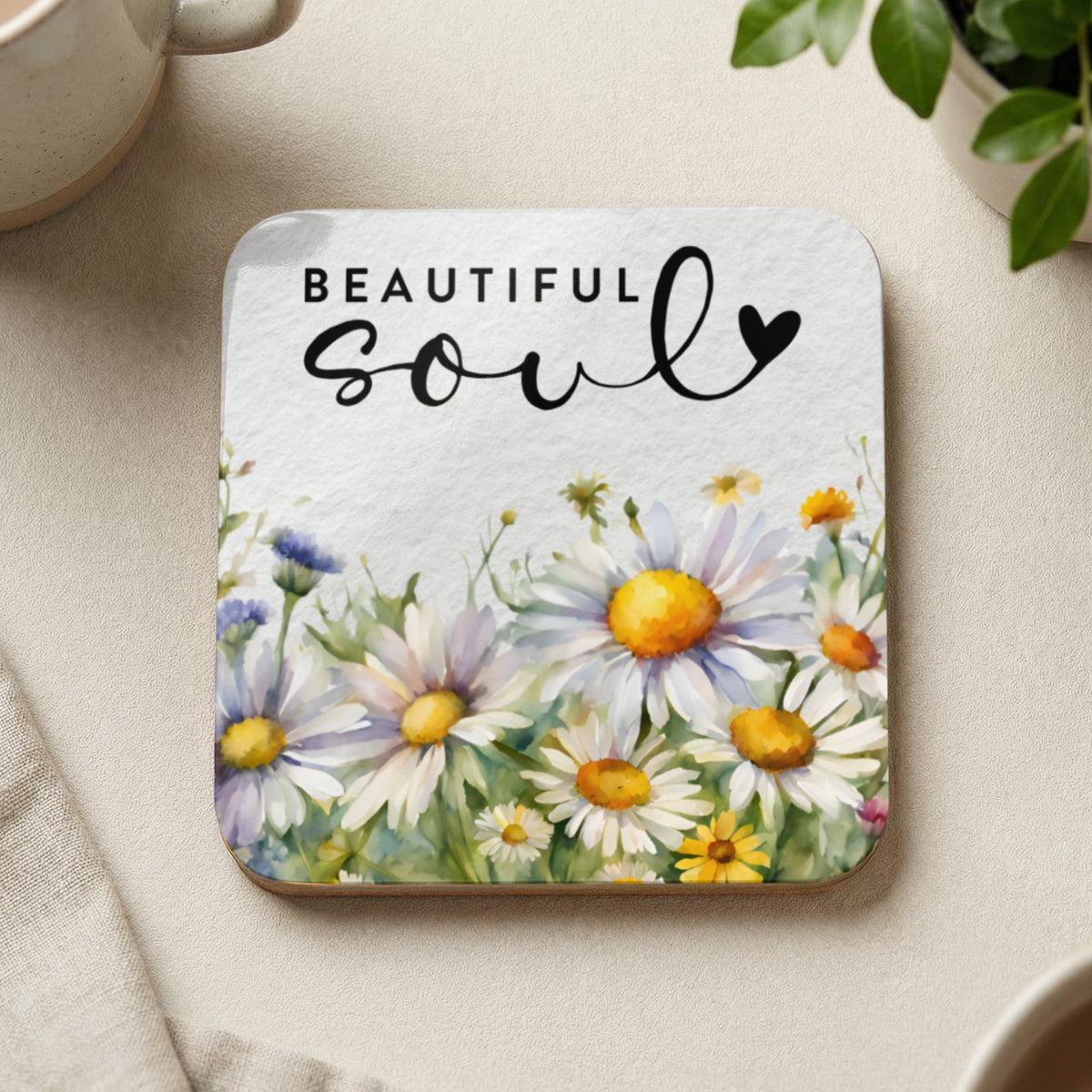 Square coaster with watercolor daisies and "BEAUTIFUL soul" text.