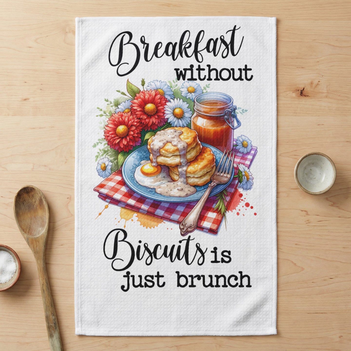 Towel with "Breakfast without Biscuits is just brunch" text and floral biscuit illustration.