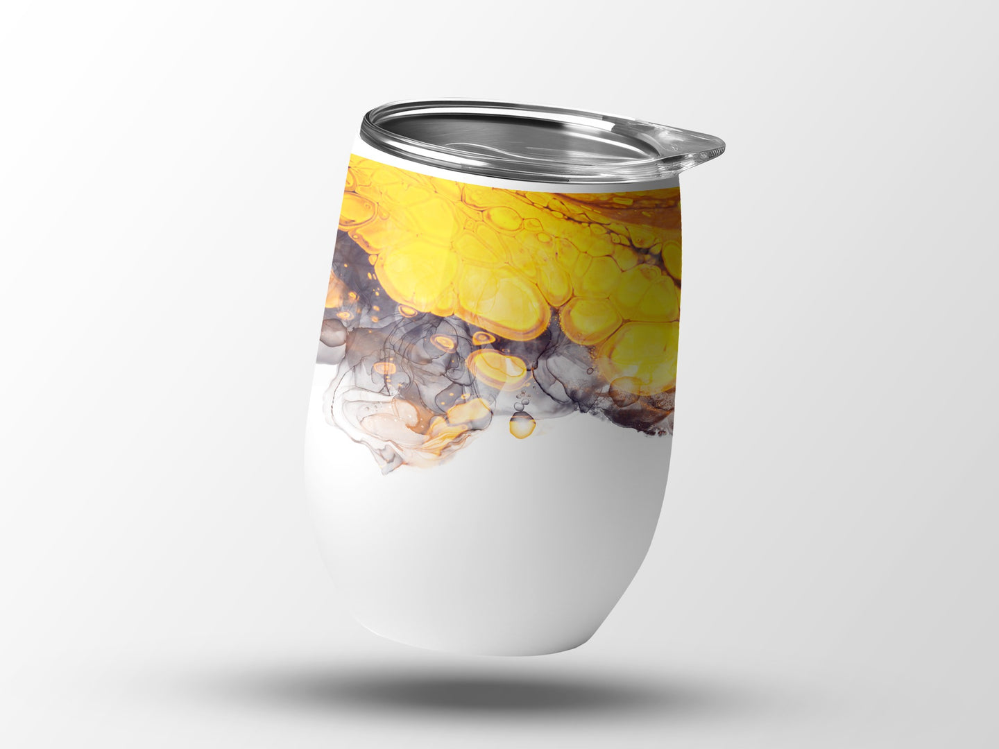White tumbler with abstract yellow and gray marbling design.
