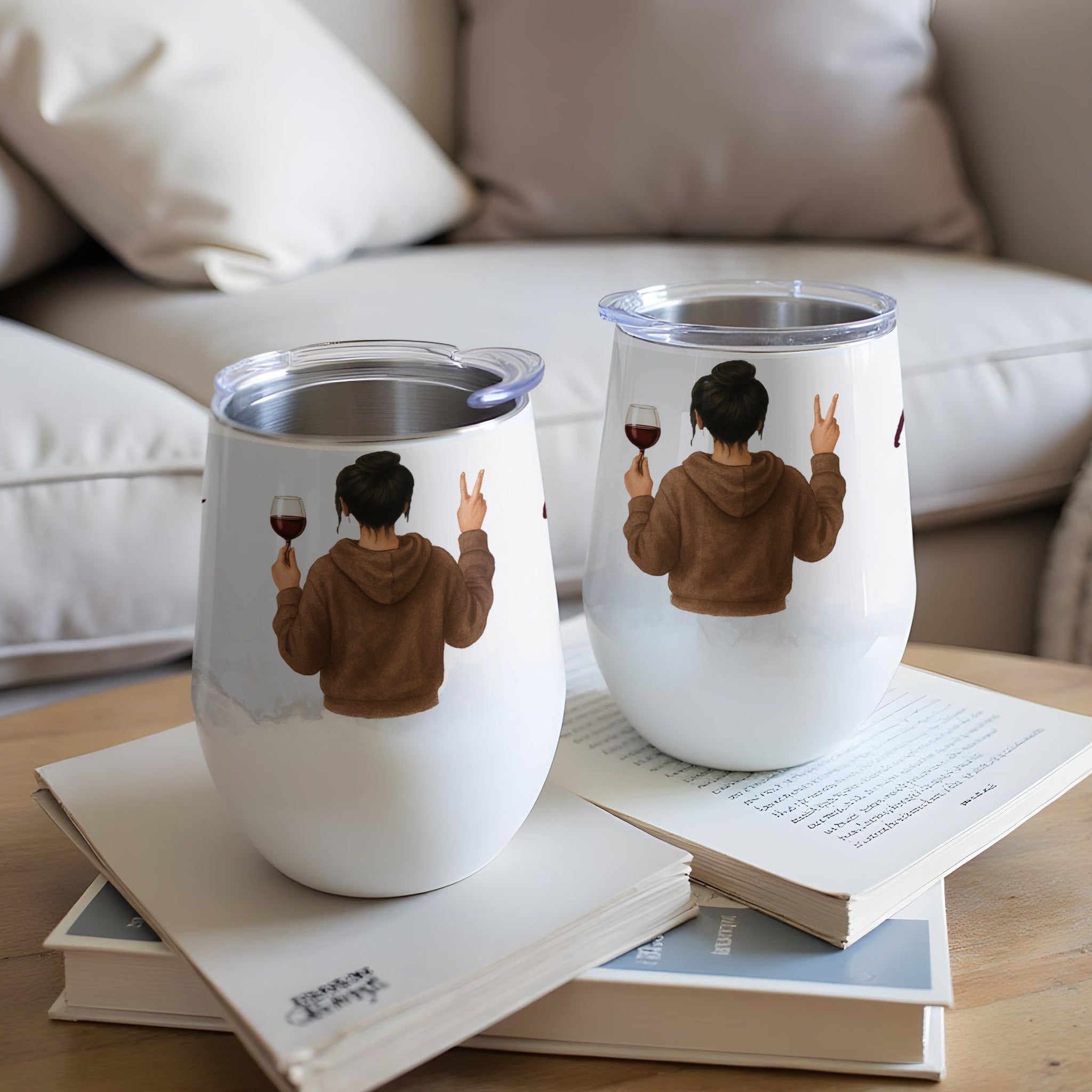 Two tumblers with illustrations of women holding wine glasses and giving peace signs.