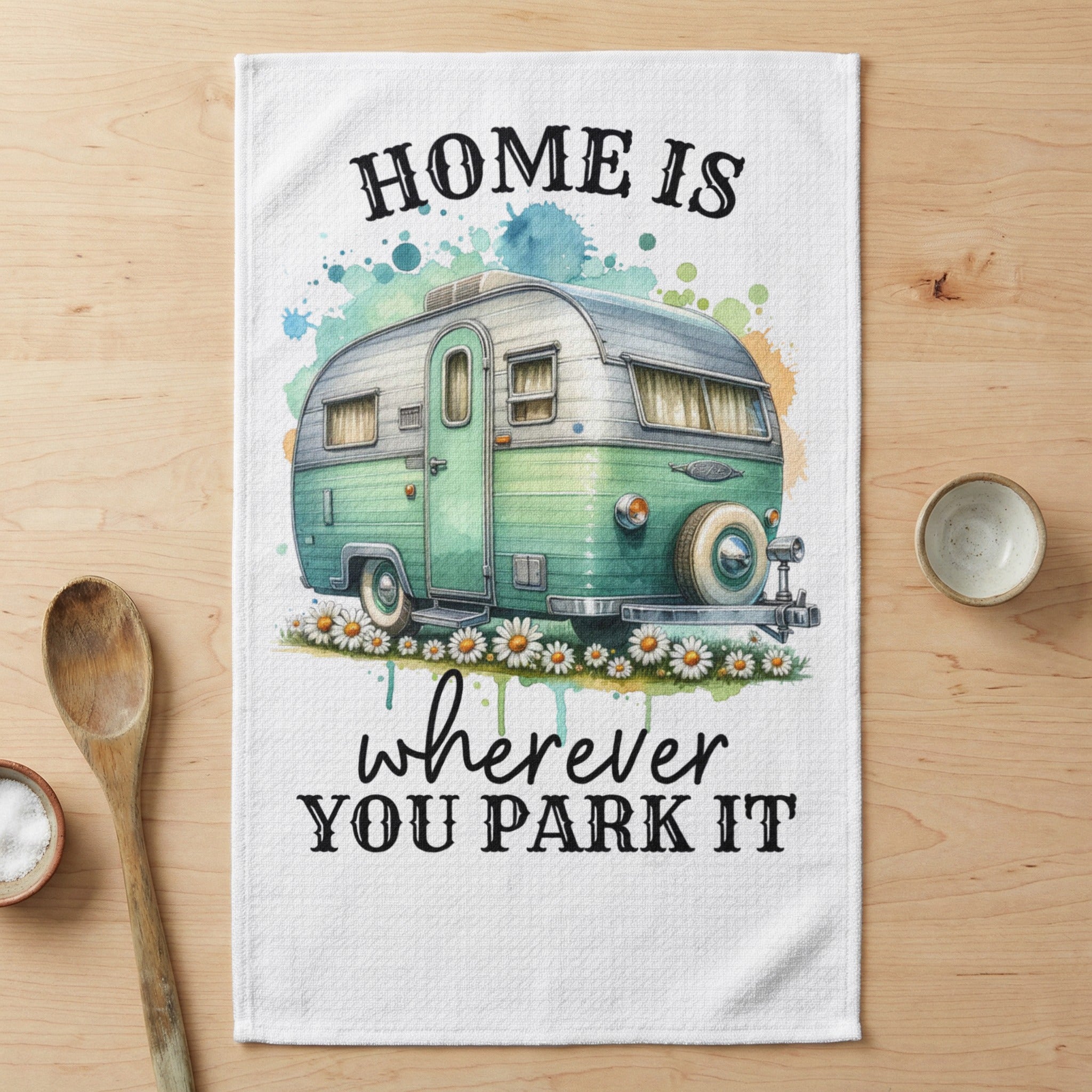Green camper trailer with "HOME IS wherever YOU PARK IT" text.