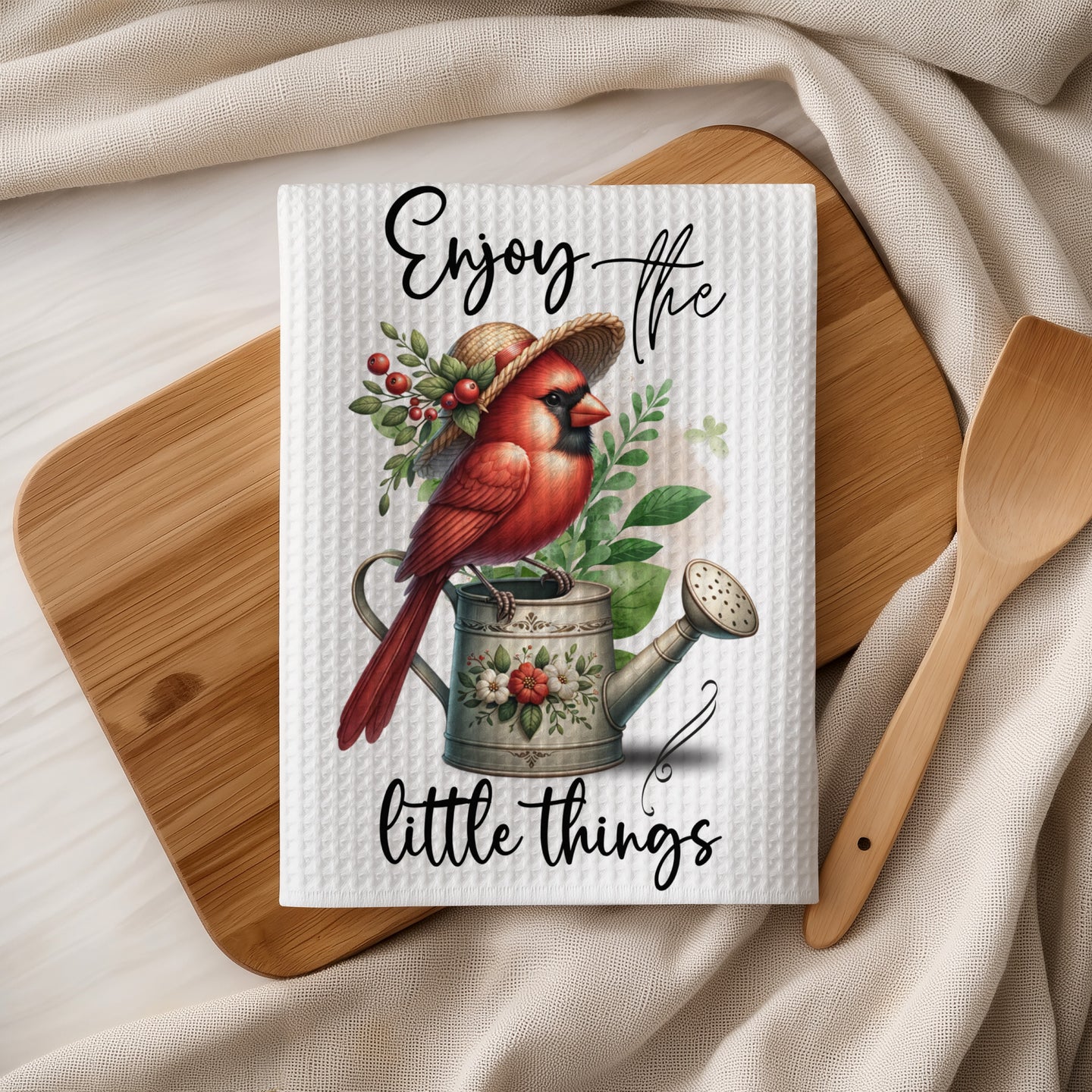 Cardinal on watering can with "Enjoy the little things" text.